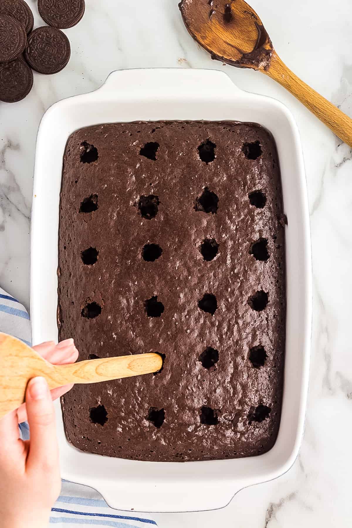 Poking holes in a chocolate cake