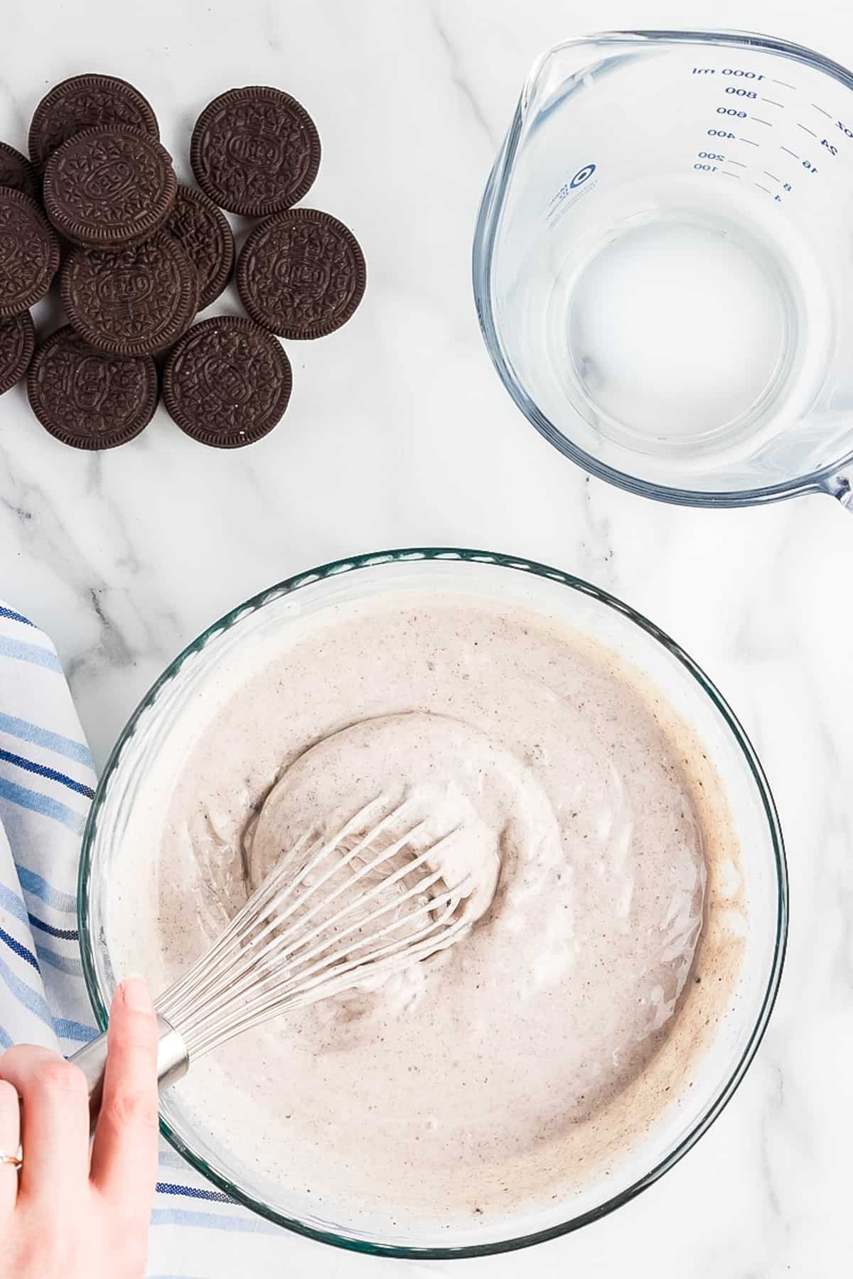 Mixing oreo pudding in glass bowl