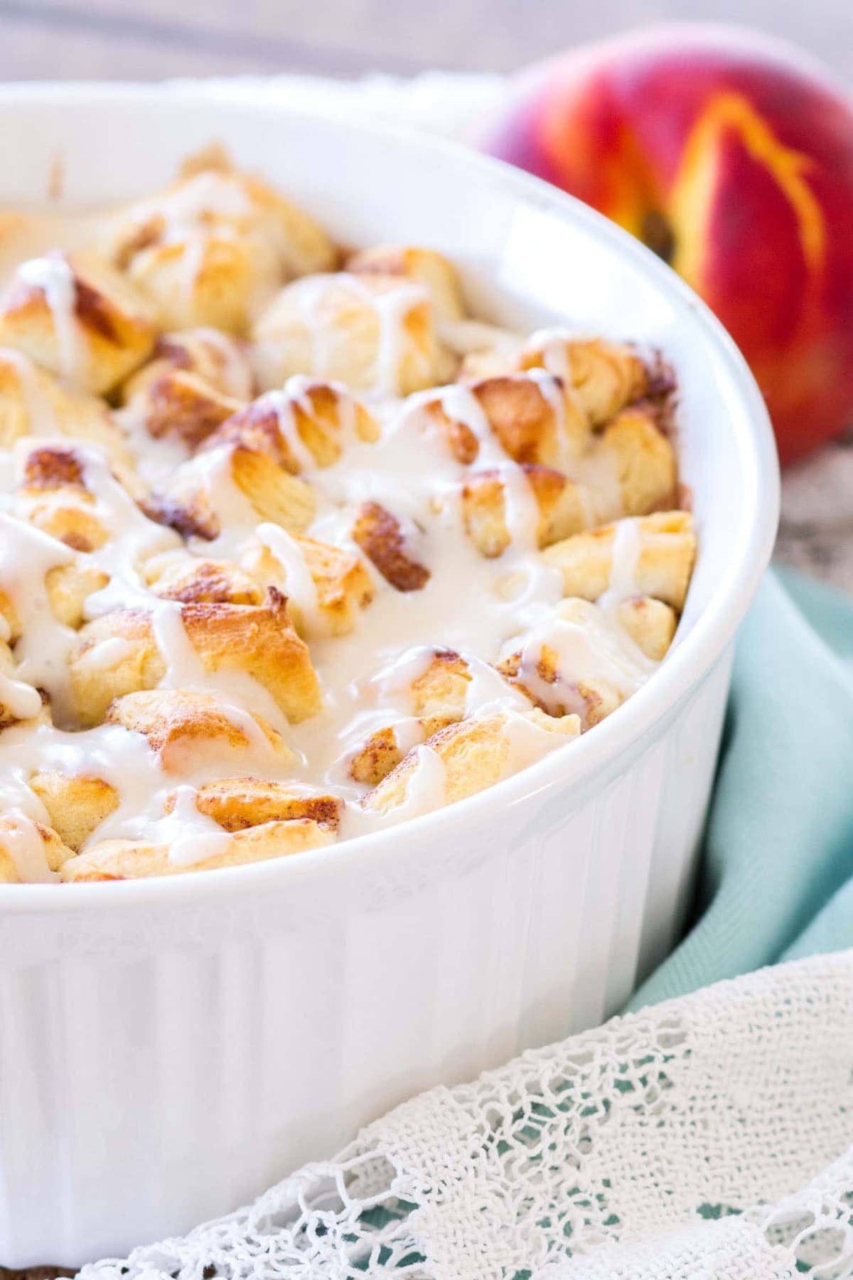 This Easy Cinnamon Roll Peach Cobbler is made with fresh peaches, sweet spices, and pre-made cinnamon roll dough. The final component of this cinnamon roll peach cobbler recipe is a sweet vanilla glaze, making this a quick and easy summer dessert! 