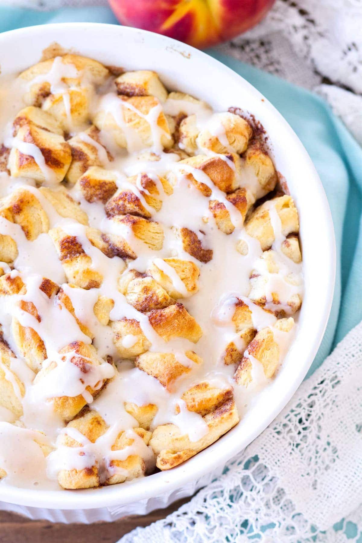 This Easy Cinnamon Roll Peach Cobbler is made with fresh peaches, sweet spices, and pre-made cinnamon roll dough. The final component of this cinnamon roll peach cobbler recipe is a sweet vanilla glaze, making this a quick and easy summer dessert! 