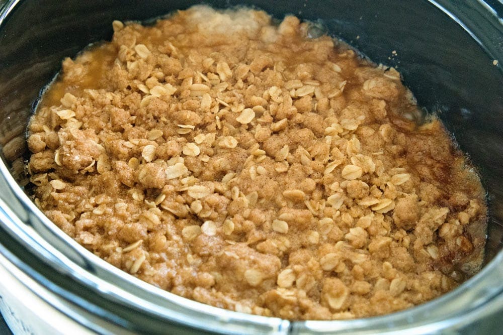 Cooked Peach crisp in Crock Pot. The oats are golden brown and it's almost ready to eat!