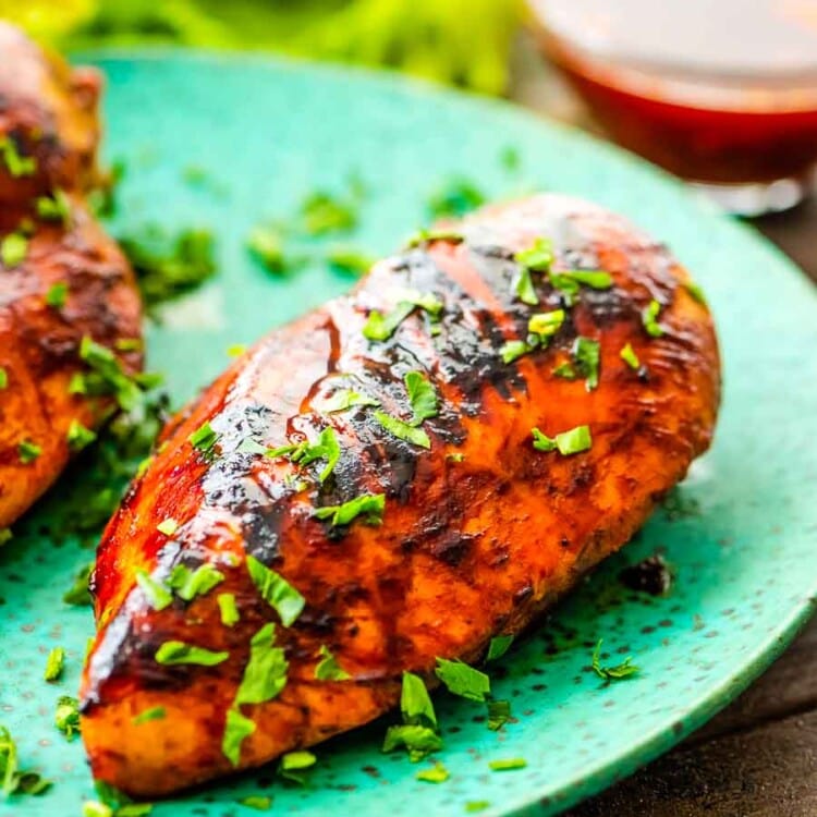 bbq chicken marinaded chicken breasts on a green plate
