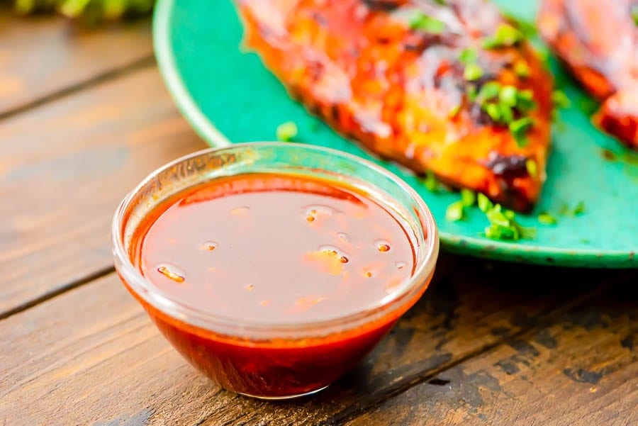 bbq chicken marinade in glass bowl on brown background