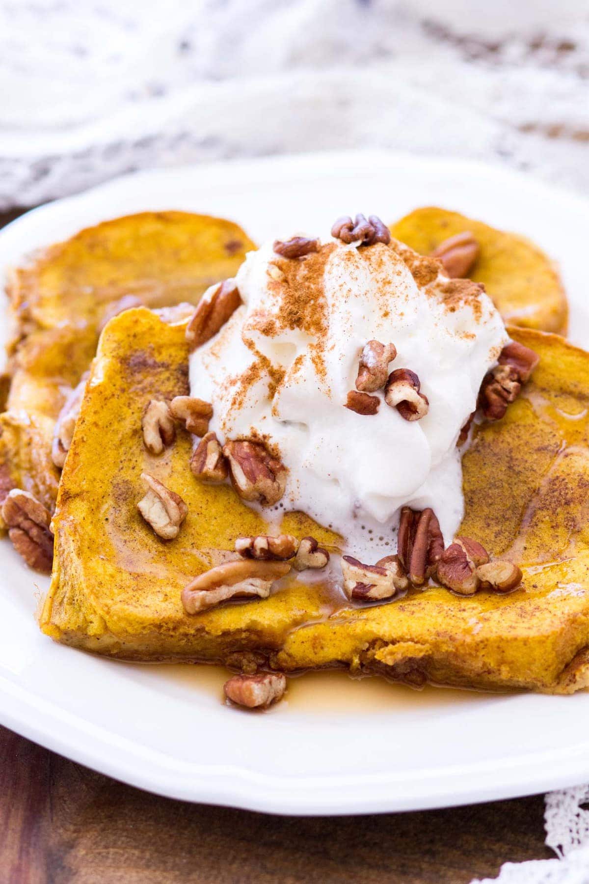 This easy pumpkin french toast recipe is baked in the oven, making this the perfect fall breakfast for any day of the week! Thick-cut bread is soaked in a rich pumpkin custard and baked to perfection! 