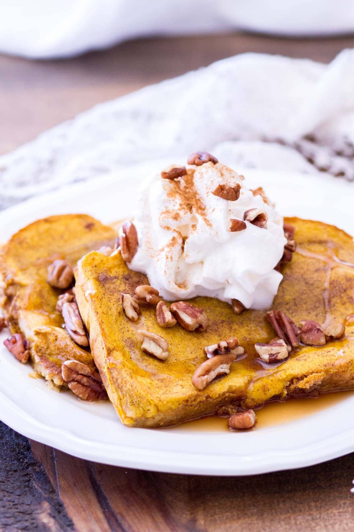 This easy pumpkin french toast recipe is baked in the oven, making this the perfect fall breakfast for any day of the week! Thick-cut bread is soaked in a rich pumpkin custard and baked to perfection! 