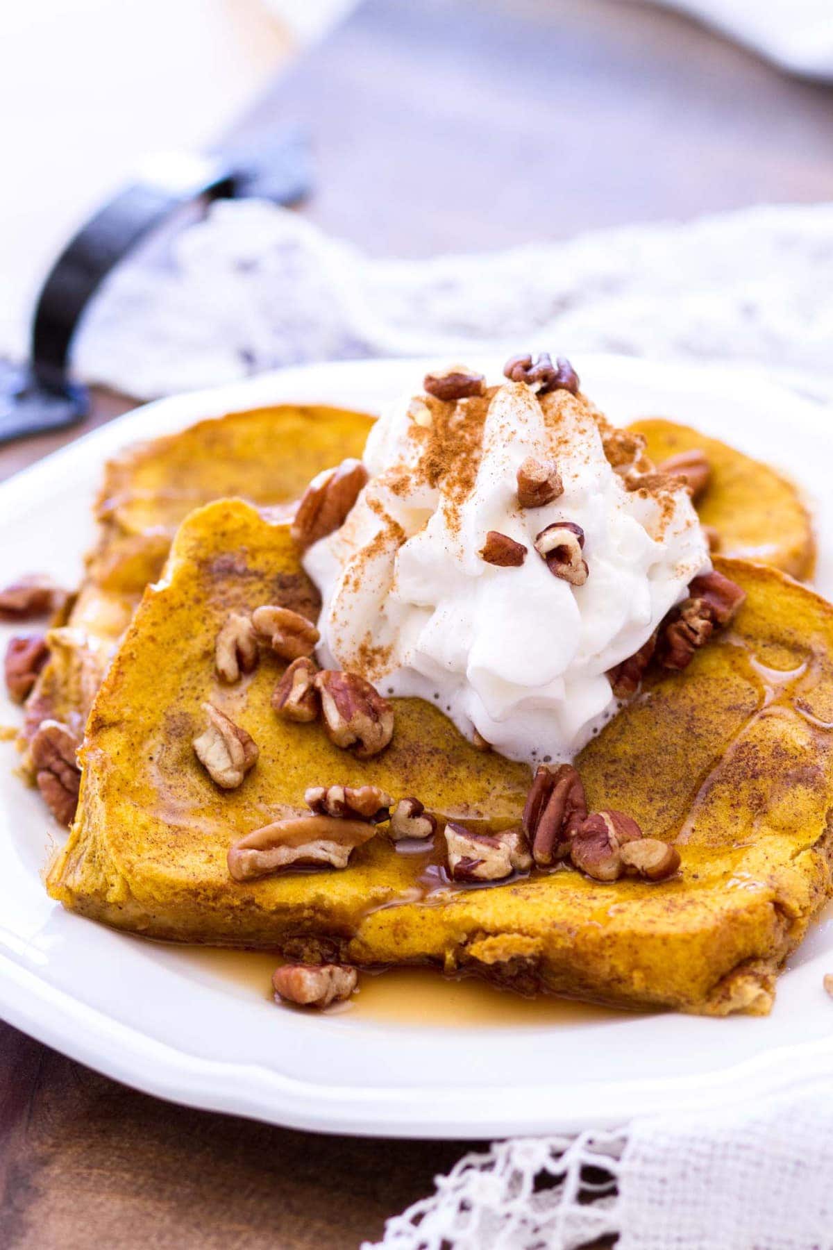 This easy pumpkin french toast recipe is baked in the oven, making this the perfect fall breakfast for any day of the week! Thick-cut bread is soaked in a rich pumpkin custard and baked to perfection! 