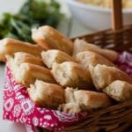 Breadsticks in a basket lined with red and white cloth