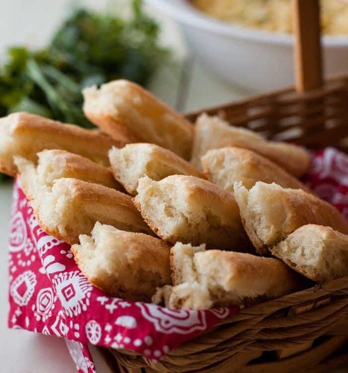 Breadsticks in a basket lined with red and white cloth