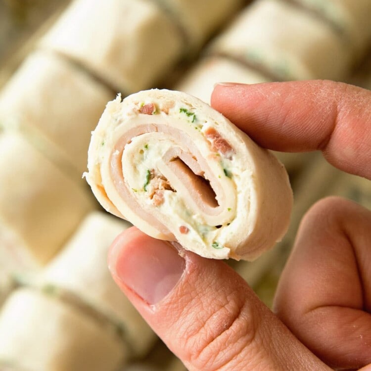 Hand holding a Cheesy Turkey Bacon Ranch Pinwheel