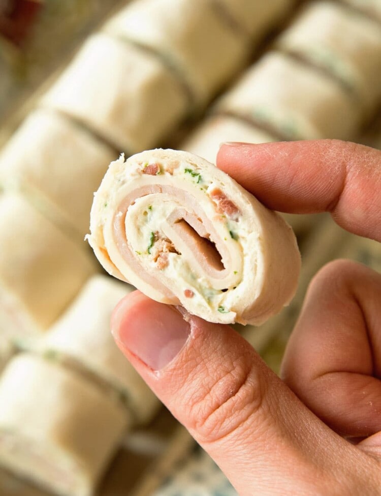 Hand holding a Cheesy Turkey Bacon Ranch Pinwheel