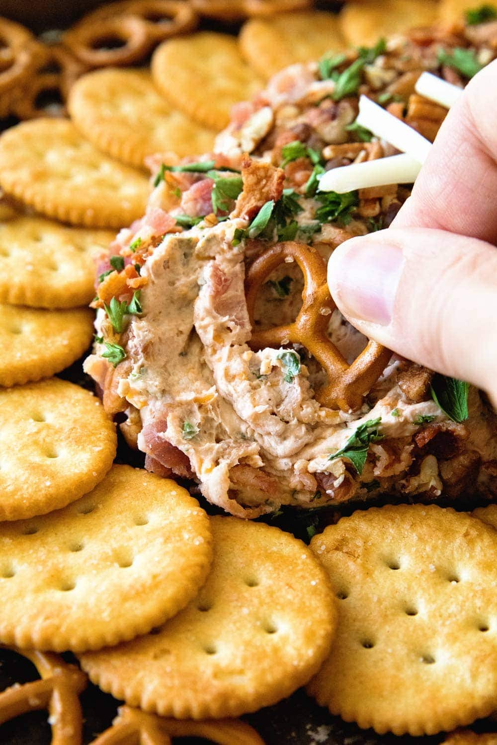 pretzel dipped into a Cheese ball with bacon and ranch 