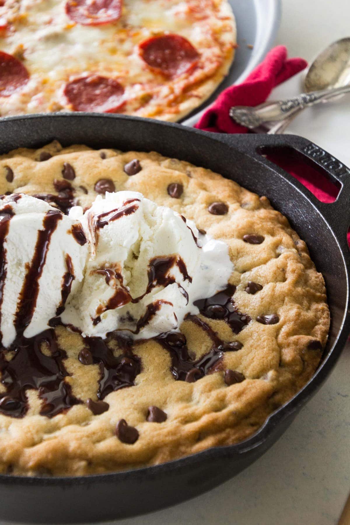  An amazing Chocolate Chip Skillet Cookie topped with ice cream and chocolate drizzle.