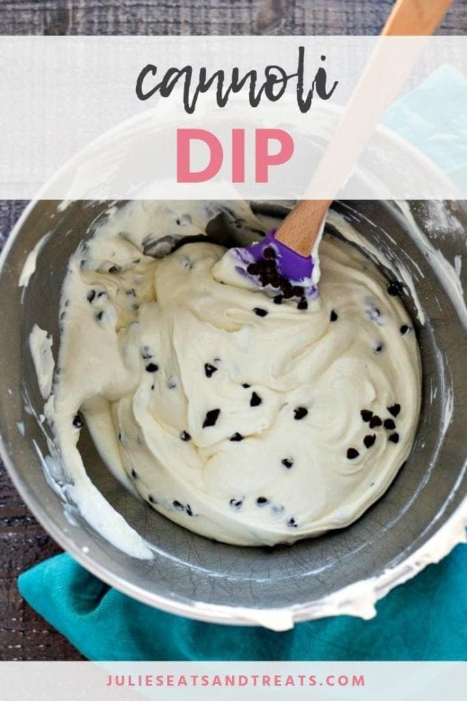Cannoli dip being mixed in a metal mixing bowl with a spatula