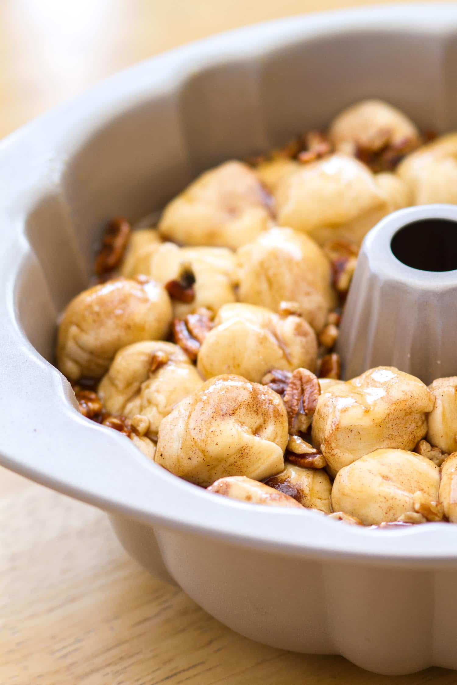 This easy maple pecan monkey bread is perfect for fall! Pre-made biscuit dough is rolled in cinnamon sugar, then baked in a maple pecan caramel sauce that is to die for! This homemade monkey bread recipe makes the best fall breakfast, or even Thanksgiving brunch! 