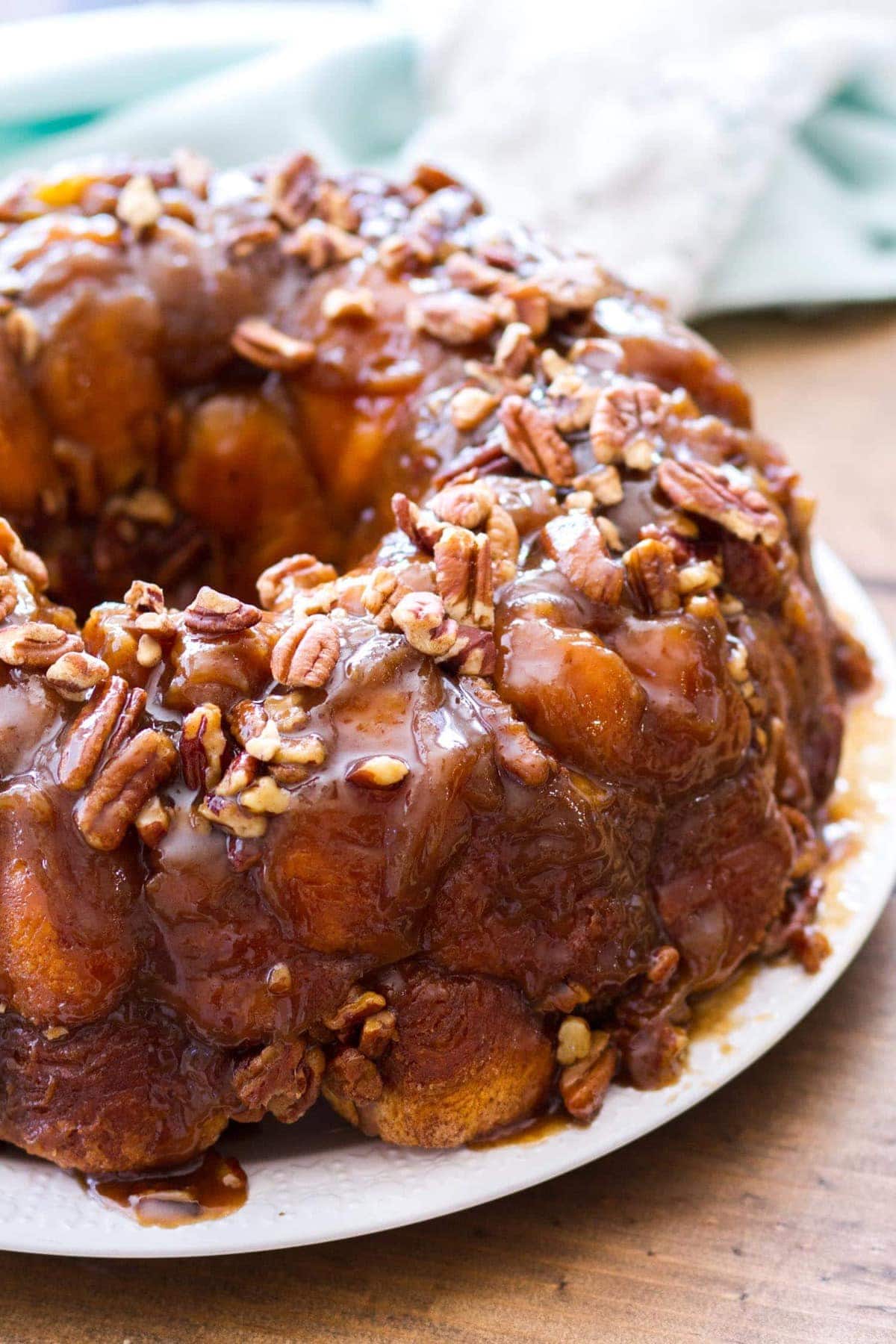 This easy maple pecan monkey bread is perfect for fall! Pre-made biscuit dough is rolled in cinnamon sugar, then baked in a maple pecan caramel sauce that is to die for! This homemade monkey bread recipe makes the best fall breakfast, or even Thanksgiving brunch! 