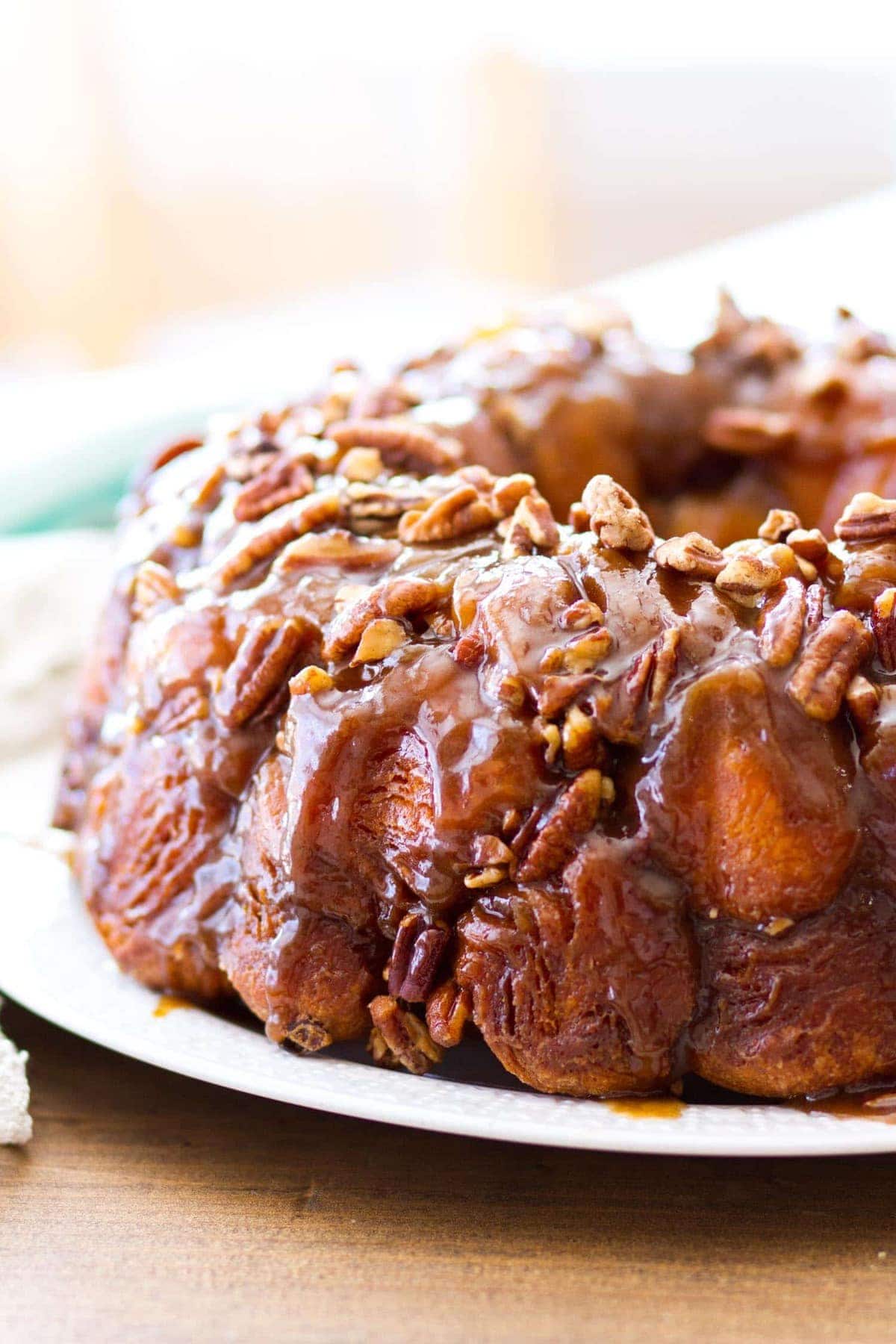 This easy maple pecan monkey bread is perfect for fall! Pre-made biscuit dough is rolled in cinnamon sugar, then baked in a maple pecan caramel sauce that is to die for! This homemade monkey bread recipe makes the best fall breakfast, or even Thanksgiving brunch! 