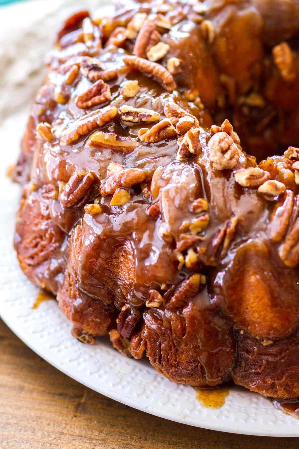 This easy maple pecan monkey bread is perfect for fall! Pre-made biscuit dough is rolled in cinnamon sugar, then baked in a maple pecan caramel sauce that is to die for! This homemade monkey bread recipe makes the best fall breakfast, or even Thanksgiving brunch! 