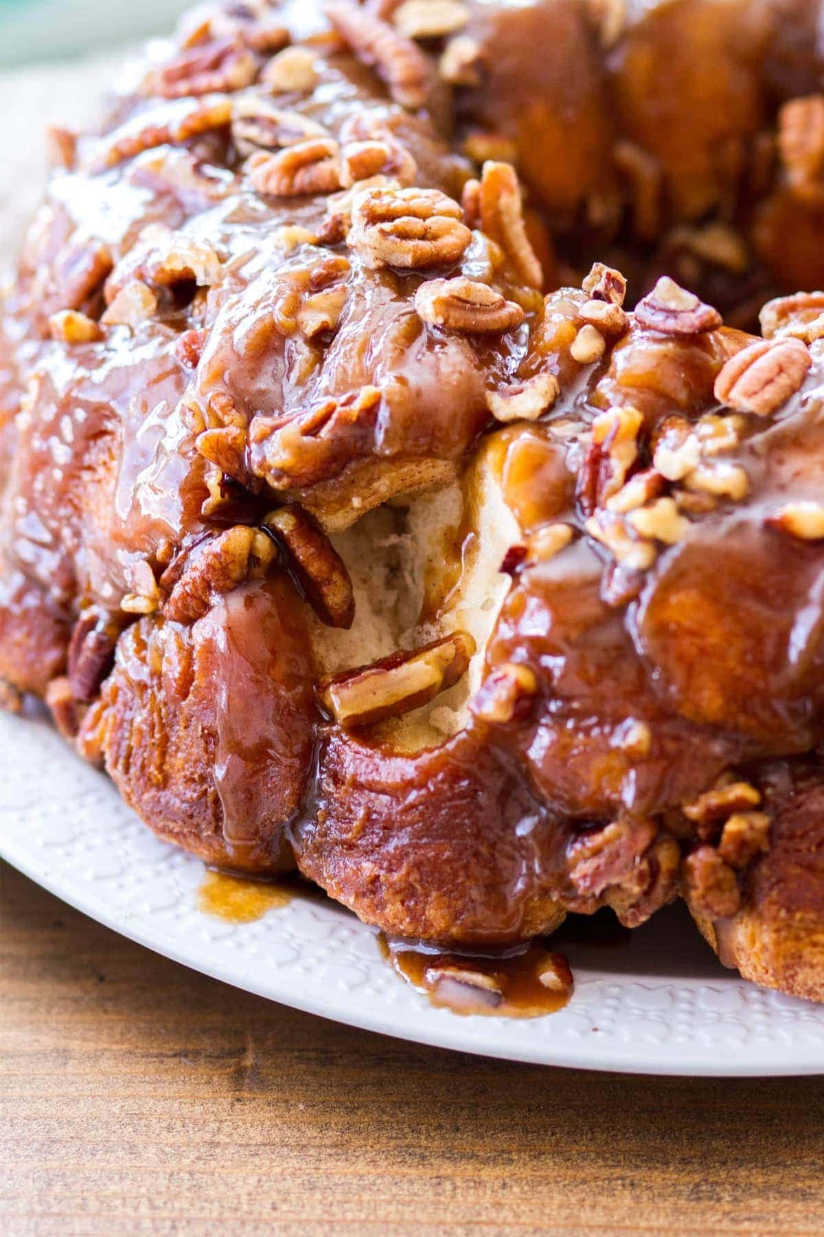 This easy maple pecan monkey bread is perfect for fall! Pre-made biscuit dough is rolled in cinnamon sugar, then baked in a maple pecan caramel sauce that is to die for! This homemade monkey bread recipe makes the best fall breakfast, or even Thanksgiving brunch! 