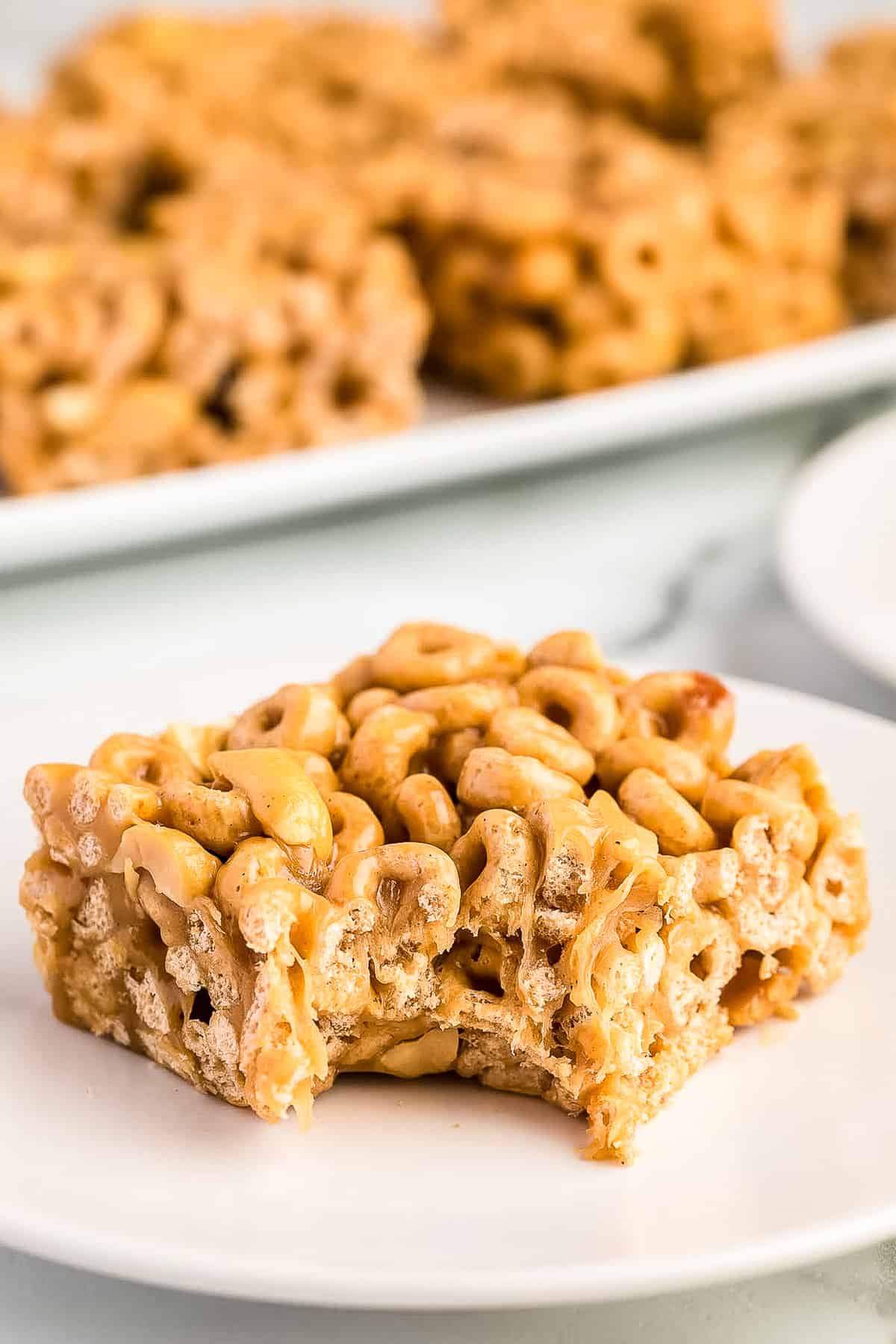 Peanut Butter Cheerio Bar on plate with bite gone