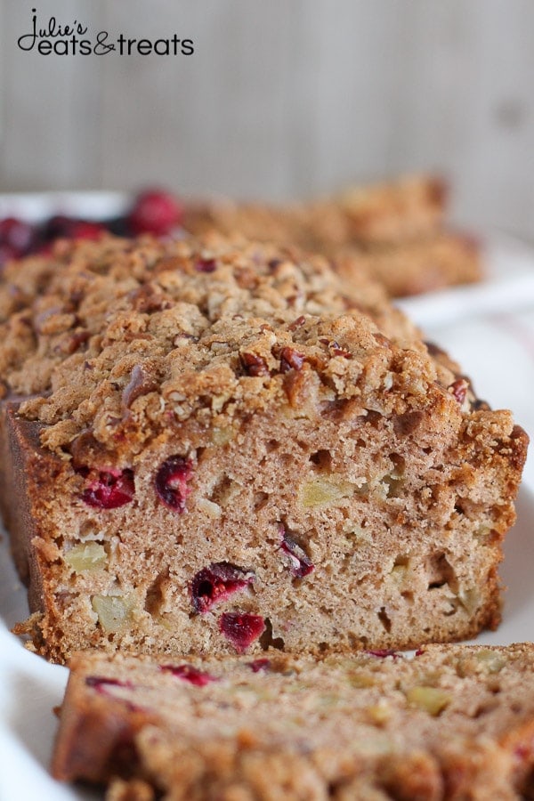 A partially sliced loaf of Apple Cranberry Bread