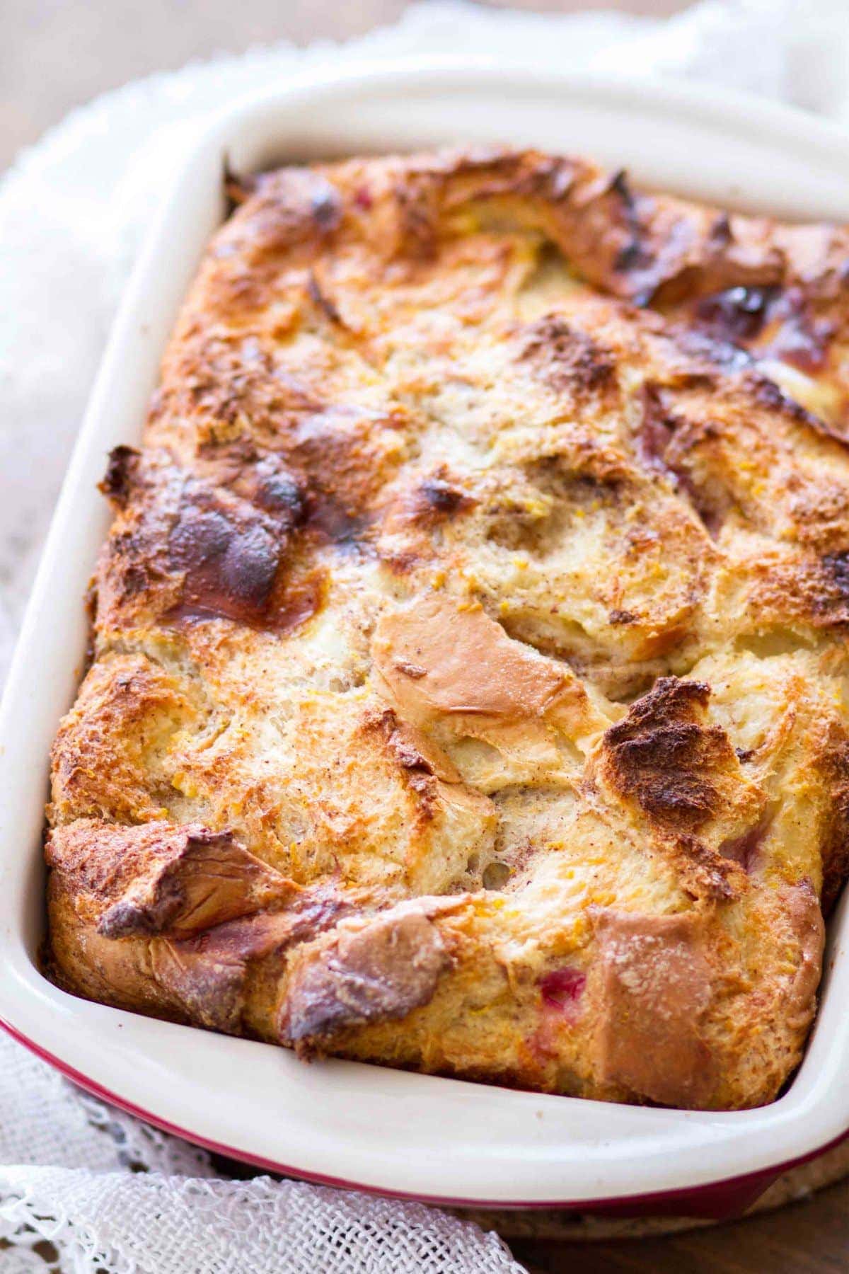 This easy homemade Cranberry Orange Bread Pudding is topped with an orange glaze, and is the perfect holiday dessert! This bread pudding recipe comes together quickly and is a total crowd pleaser!