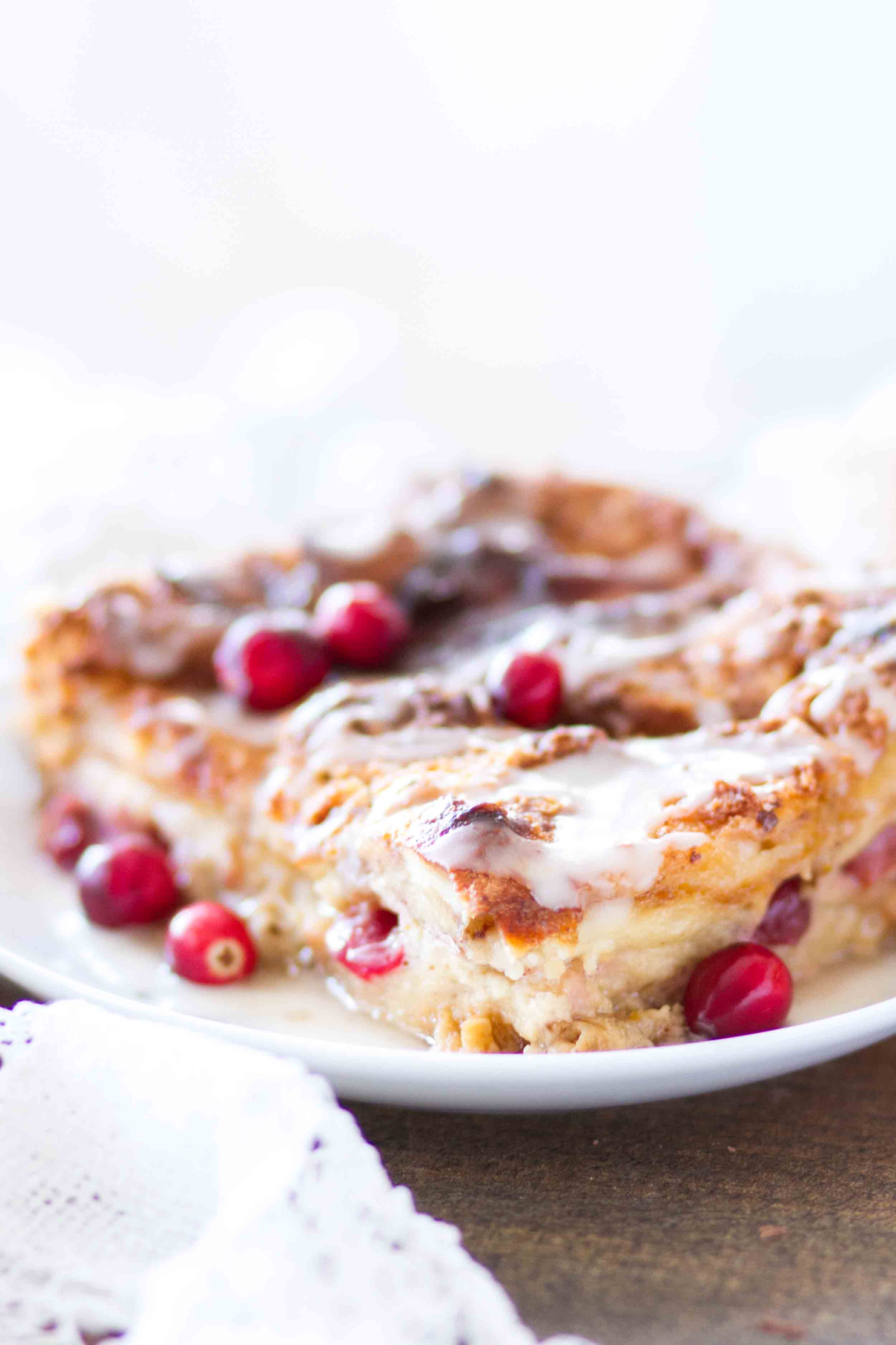 This easy homemade Cranberry Orange Bread Pudding is topped with an orange glaze, and is the perfect holiday dessert! This bread pudding recipe comes together quickly and is a total crowd pleaser!