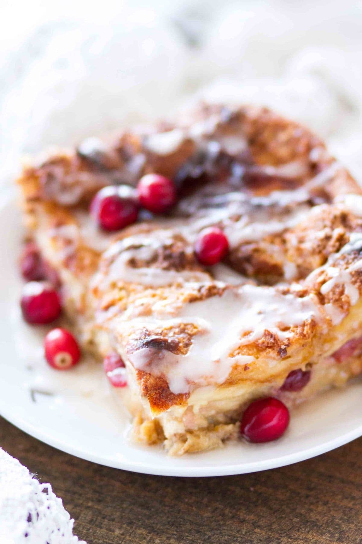 This easy homemade Cranberry Orange Bread Pudding is topped with an orange glaze, and is the perfect holiday dessert! This bread pudding recipe comes together quickly and is a total crowd pleaser!