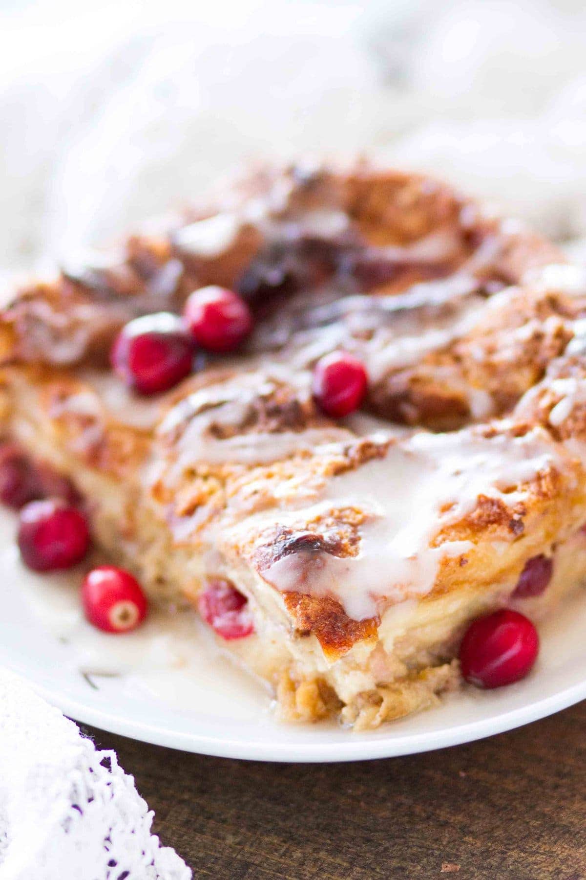 This easy homemade Cranberry Orange Bread Pudding is topped with an orange glaze, and is the perfect holiday dessert! This bread pudding recipe comes together quickly and is a total crowd pleaser!