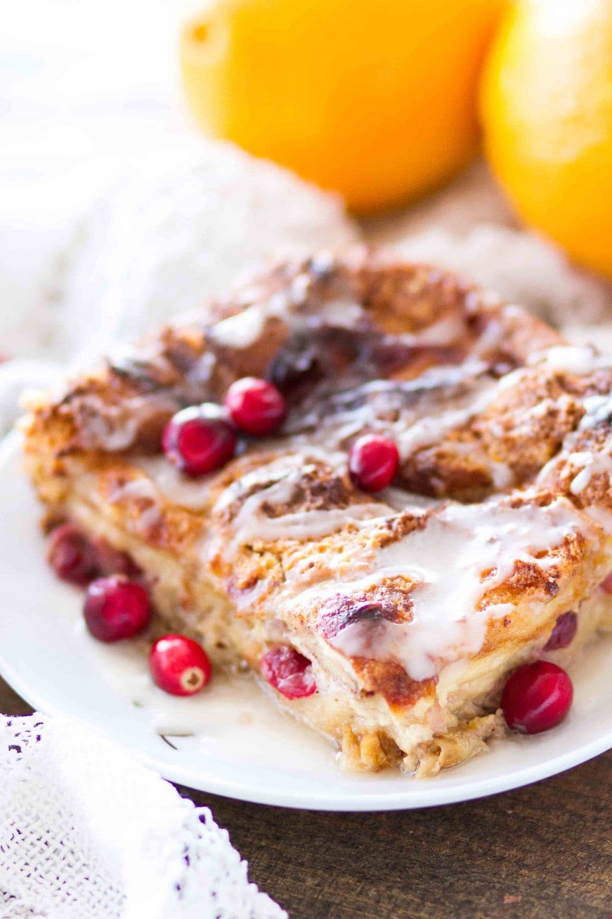 This easy homemade Cranberry Orange Bread Pudding is topped with an orange glaze, and is the perfect holiday dessert! This bread pudding recipe comes together quickly and is a total crowd pleaser!