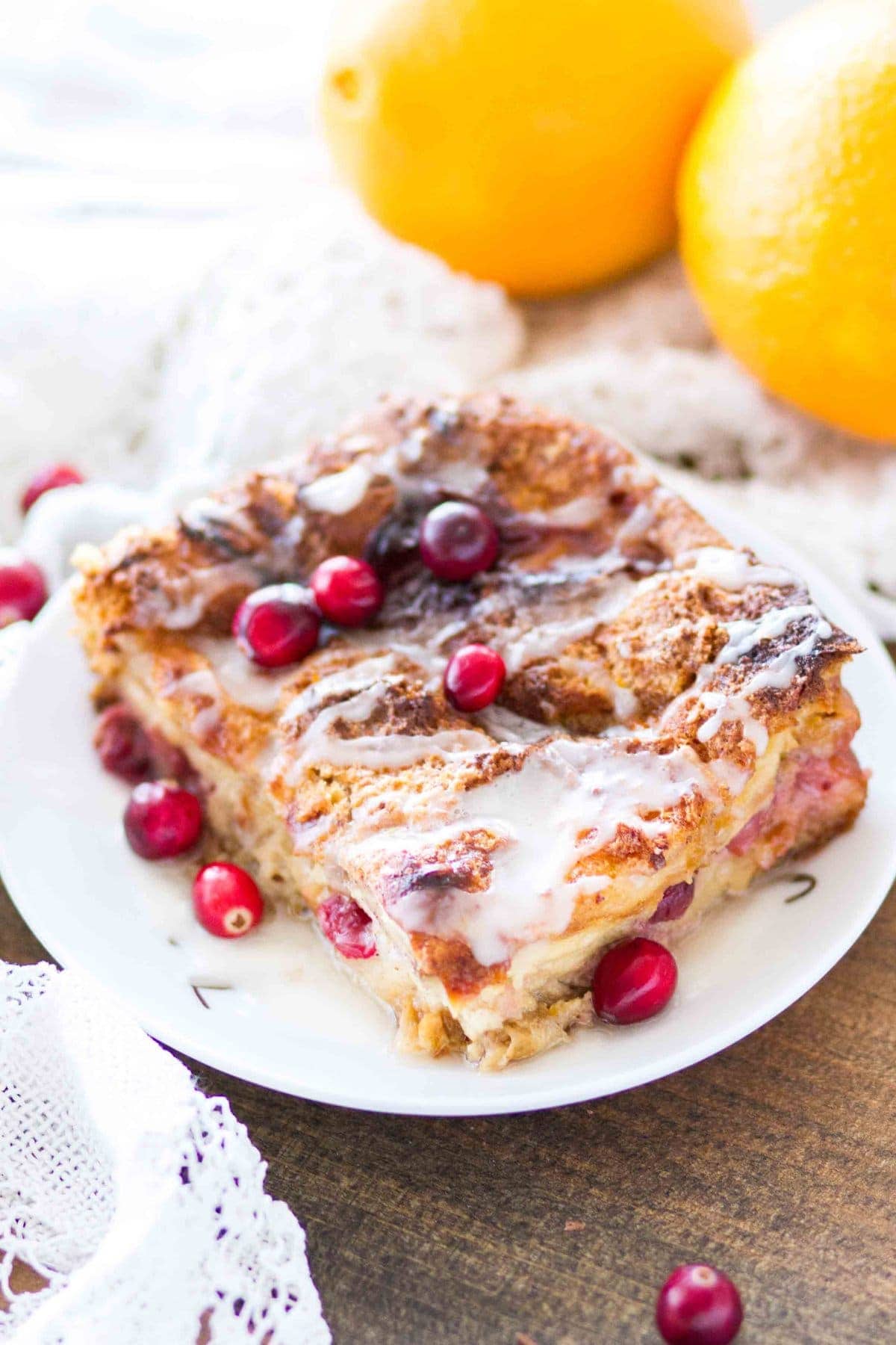 This easy homemade Cranberry Orange Bread Pudding is topped with an orange glaze, and is the perfect holiday dessert! This bread pudding recipe comes together quickly and is a total crowd pleaser!