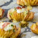 Hasselback potatoes on a parchment paper lined baking sheet