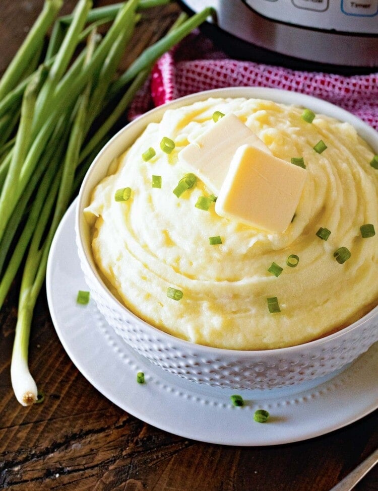 {Instant Pot} Pressure Cooker Mashed Potatoes topped with butter and green onions