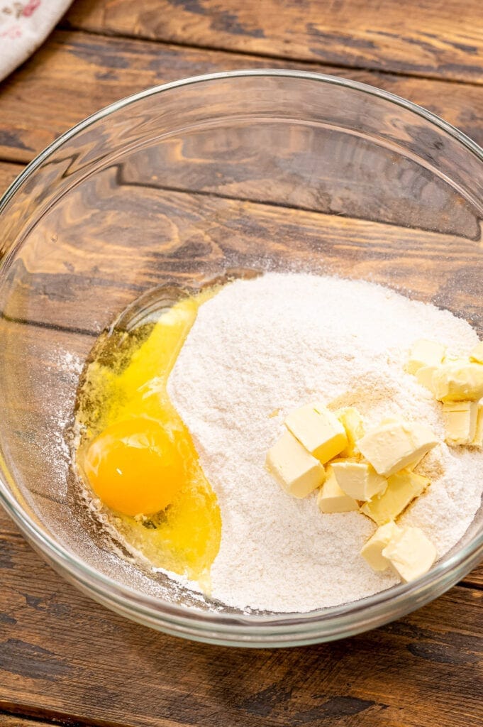 Glass bowl with ingredients to make cake mix crust.