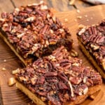 Cut pecan pie bars on board