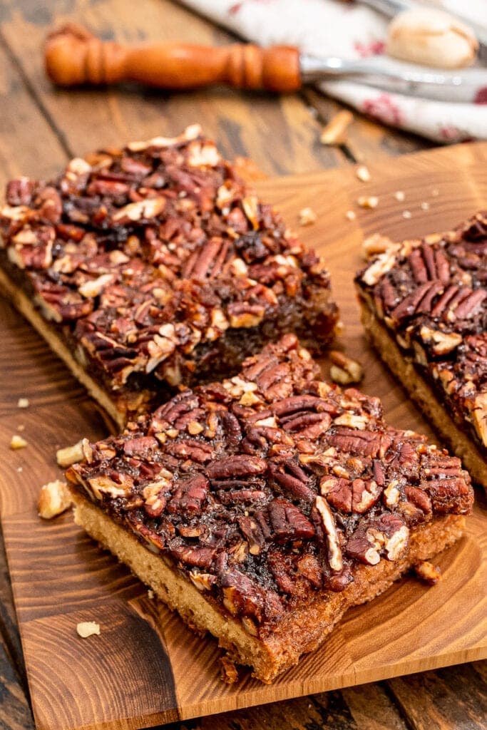 Cut pecan pie bars on board