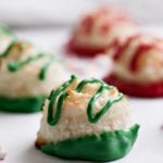 Red and green peppermint macaroons on a white surface
