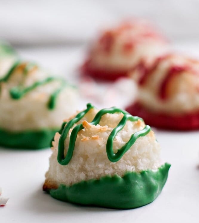 Red and green peppermint macaroons on a white surface