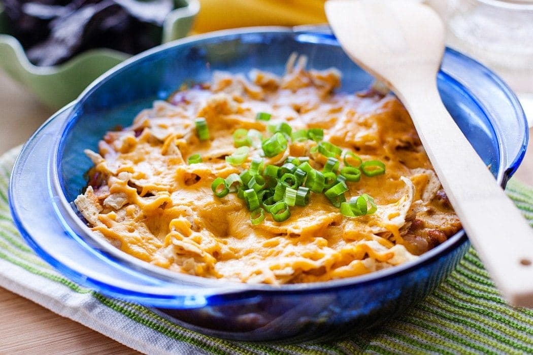 Easy Mexican Casserole with traditional Mexican spices, beans, beef, chips, and cheese.