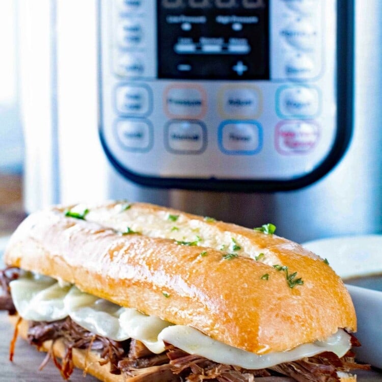 French Dip Sandwich in front of a Pressure Cooker