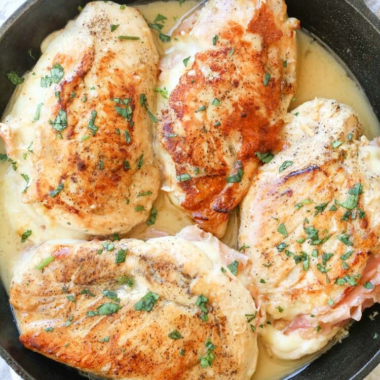 Four Chicken Breasts stuffed with Ham & Cheese in a lemon butter sauce in a cast iron skillet