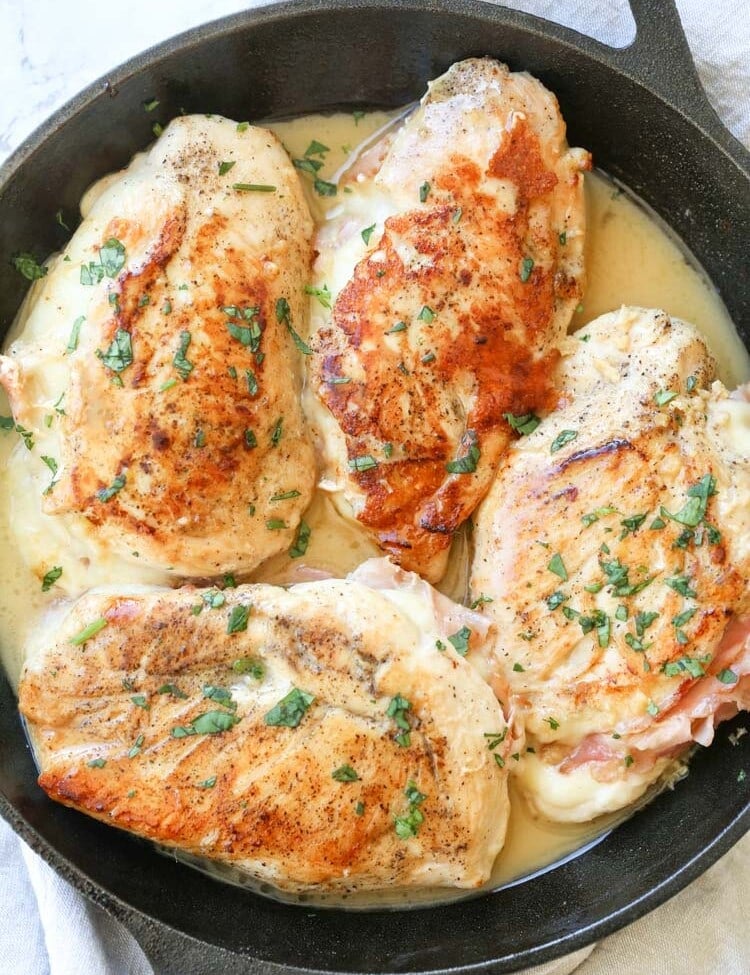 Four Chicken Breasts stuffed with Ham & Cheese in a lemon butter sauce in a cast iron skillet