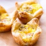 Quiche cups with ham and cheddar cheese on a piece of paper