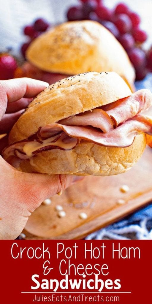 Hand holding a crock pot hot ham and cheese sandwiches