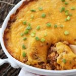 Enchilada casserole in a white oval baking dish