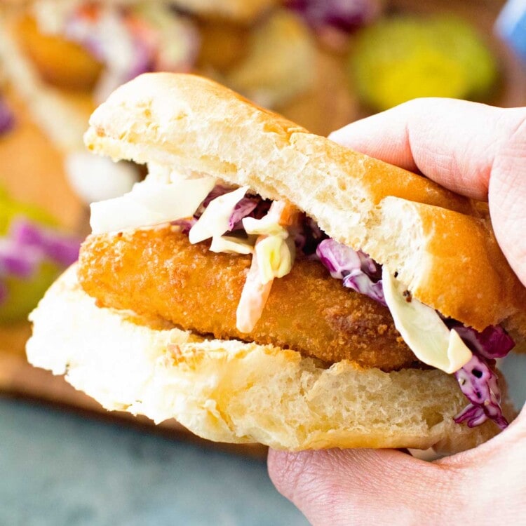 Fish stick Sandwich with garlic aioli coleslaw in hand