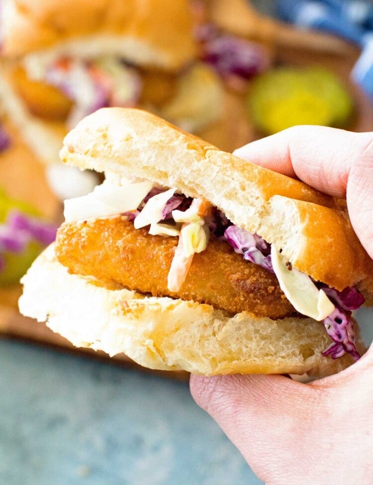 Fish stick Sandwich with garlic aioli coleslaw in hand