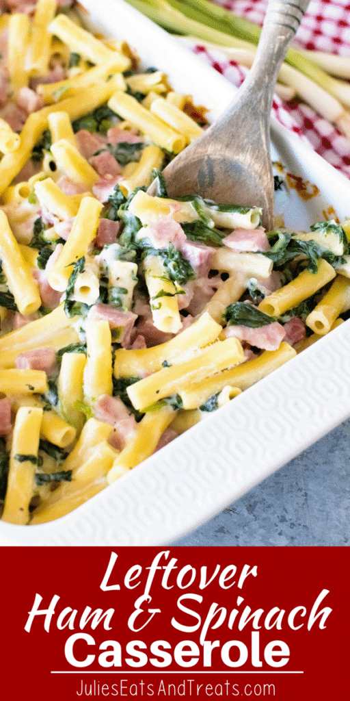 A white baking dish of leftover ham and spinach casserole with a wood spoon in it
