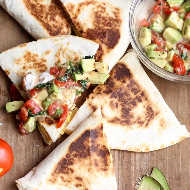 Mexican breakfast quesadillas with avocado salsa in a clear glass bowl