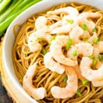 Asian Shrimp Scampi in white bowl on a wood tray