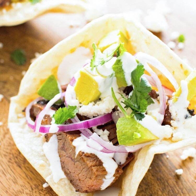 Flank Steak in homemade taco bowl on a wooden table